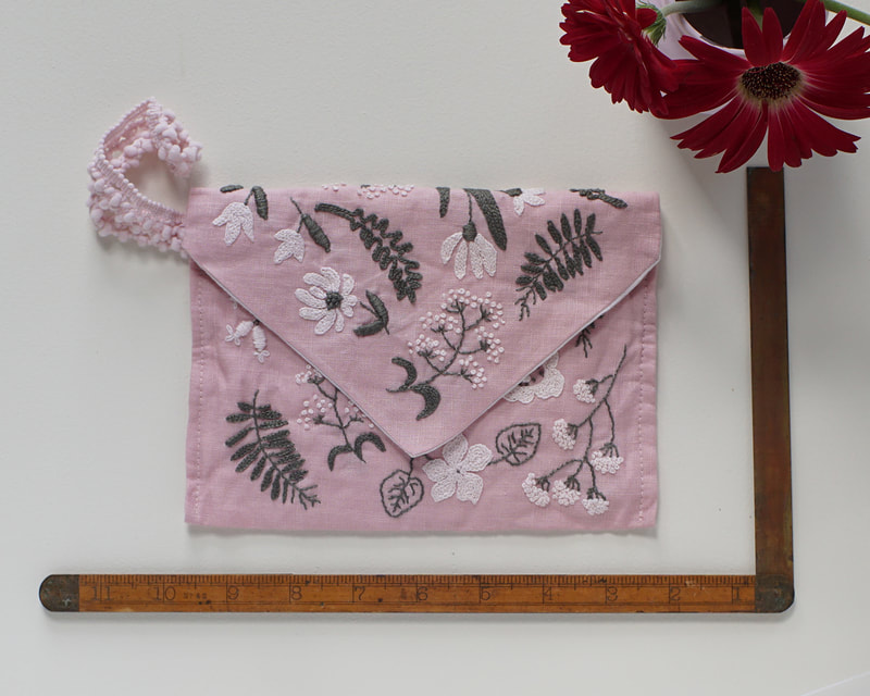 Hand-embroidered  pink linen clutch